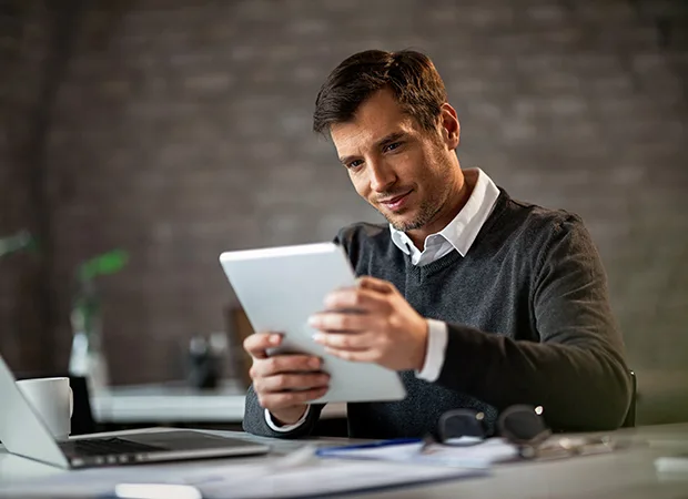 happy-entrepreneur-using-digital-tablet